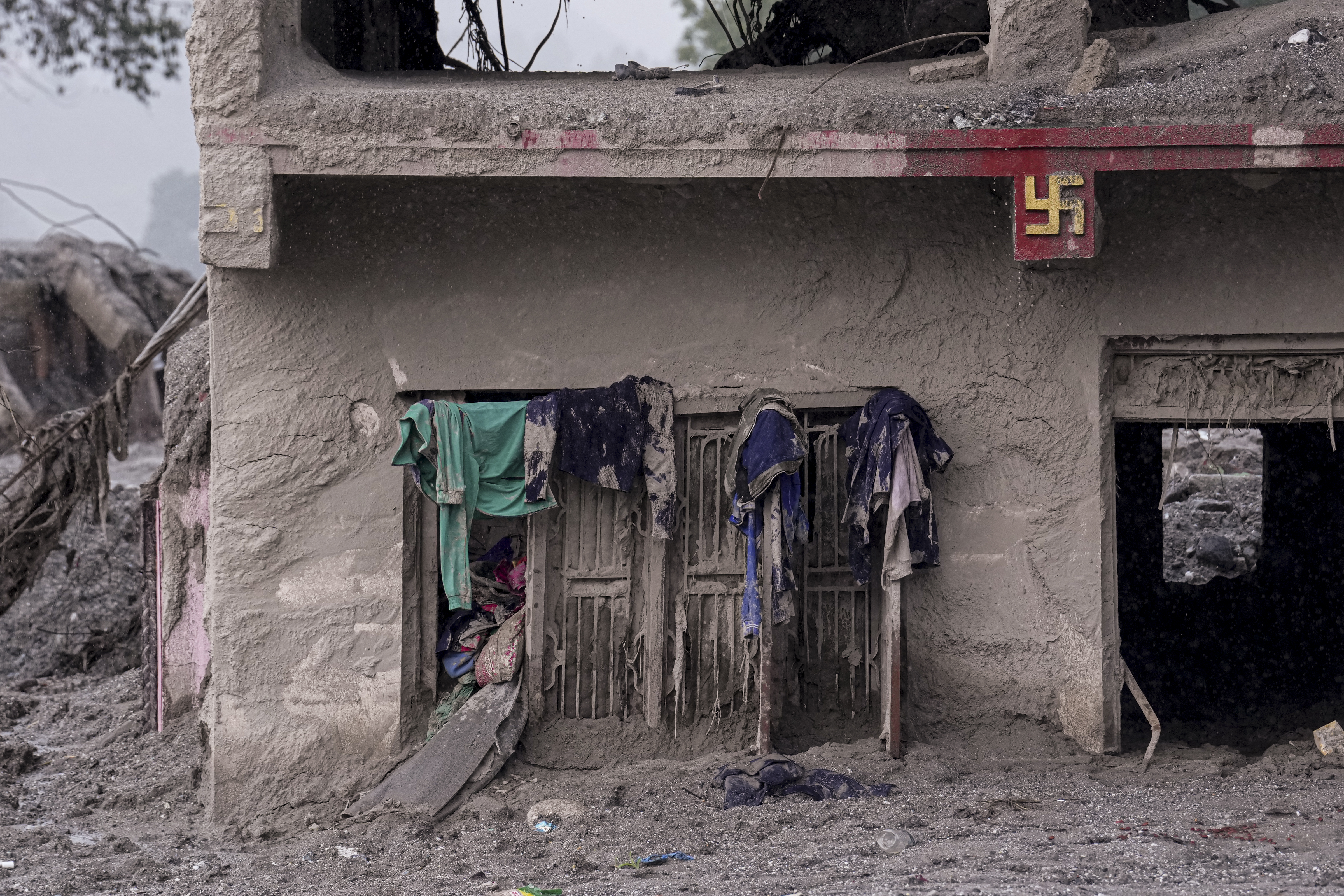 Nuwakot: Mud-covered clothes hang outside a window of a partially buried house along the Trishuli River, at Devighat, in Nuwakot district, Nepal, Friday, Sept. 4, 2026. The region was struck by devastating flash floods and mudslides following a high-altitude glacier collapse in late August. (PTI Photo/Karma Bhutia)(PTI09_04_2026_000188B)