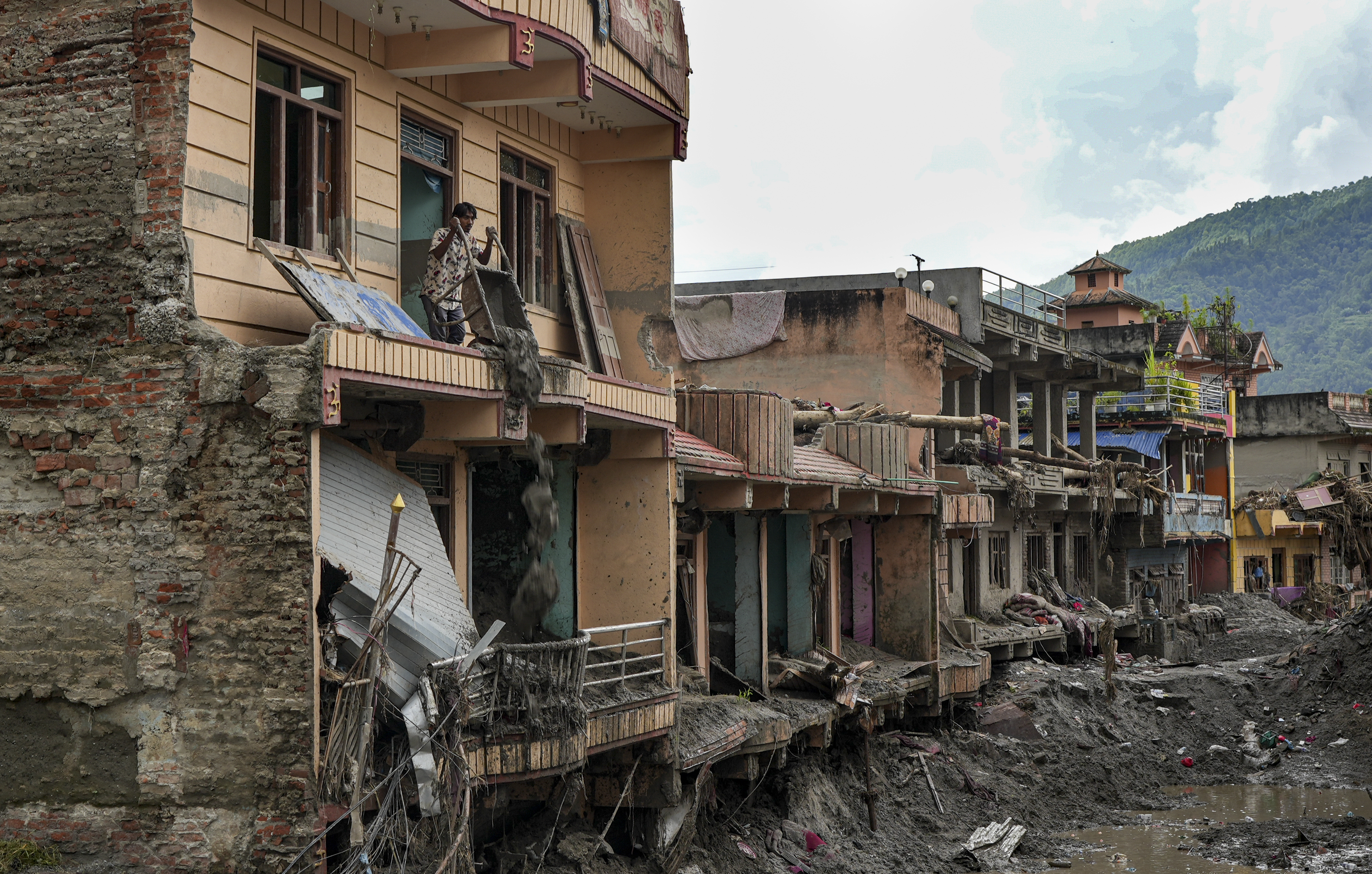 Nuwakot: A resident uses a wheelbarrow to dump mud and sludge out of an upper floor of a damaged building along the Trishuli River, at Devighat, in Nuwakot district, Nepal, Friday, Sept. 4, 2026. The region was struck by devastating flash floods and mudslides following a high-altitude glacier collapse in late August. (PTI Photo/Karma Bhutia)(PTI09_04_2026_000191A)